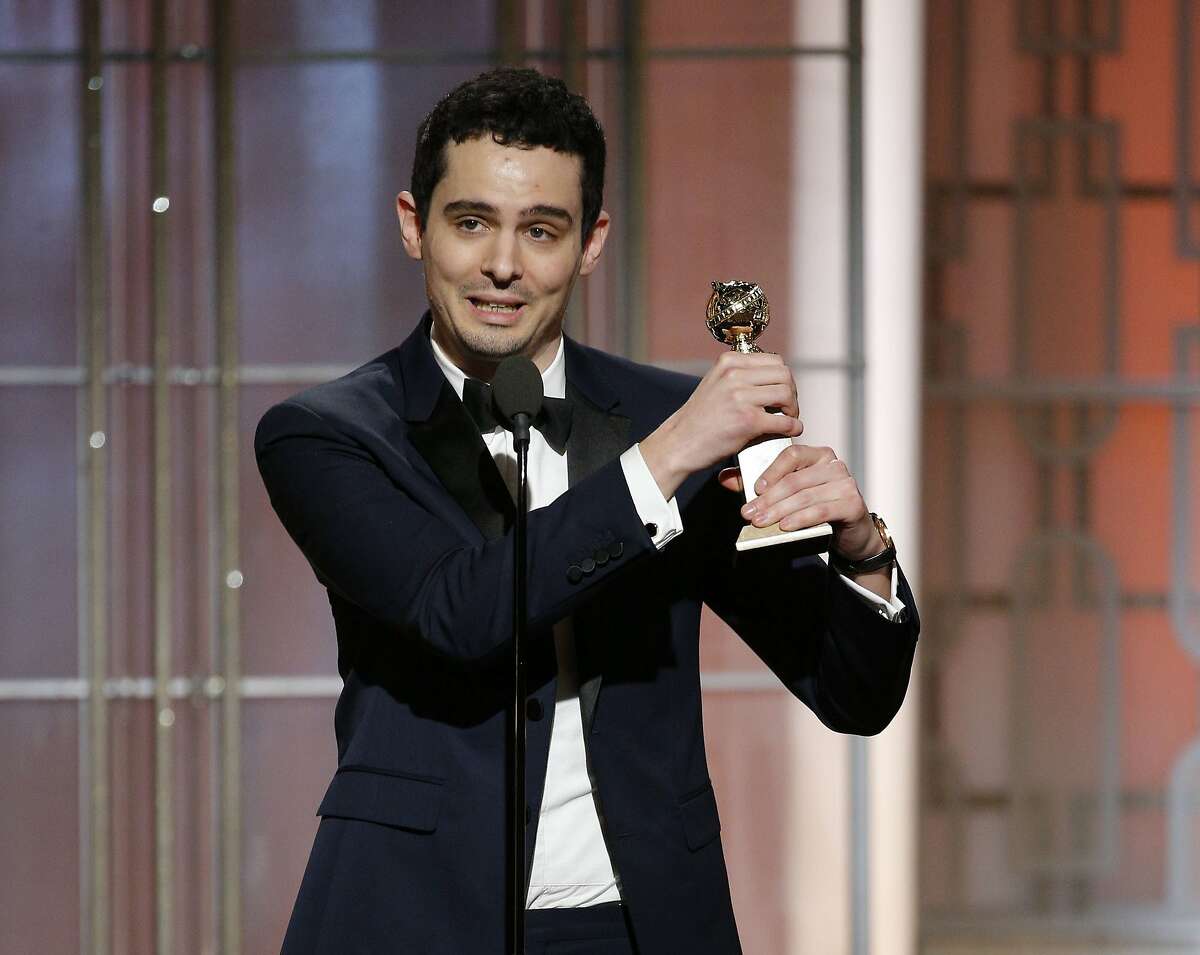 This image released by NBC shows Damien Chazelle with the award for best screenplay for "La La Land," at the 74th Annual Golden Globe Awards at the Beverly Hilton Hotel in Beverly Hills, Calif., on Sunday, Jan. 8, 2017. (Paul Drinkwater/NBC via AP)