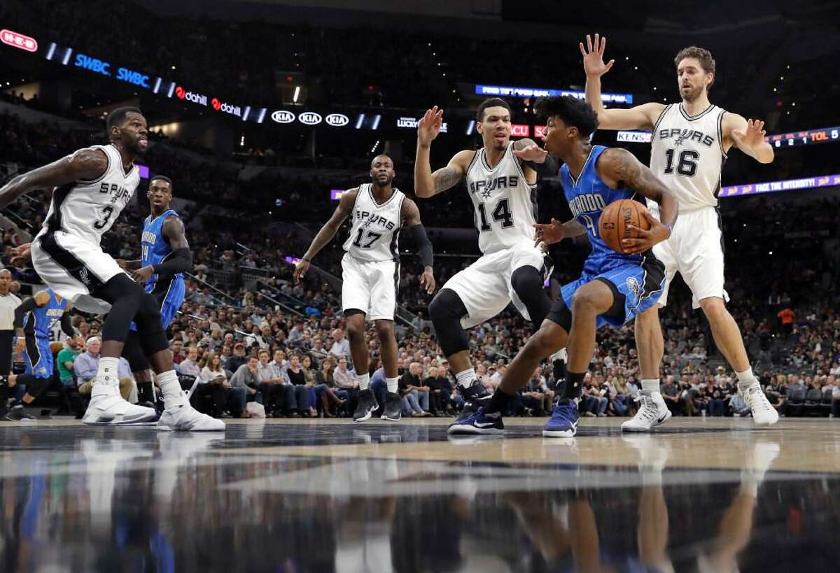 Orlando Magic guard Elfrid Payton (4) is pressured by San Antonio Spurs defenders Danny Green (14) and Pau Gasol (16) during the first half of an NBA basketball game, Tuesday, Nov. 29, 2016, in San Antonio.