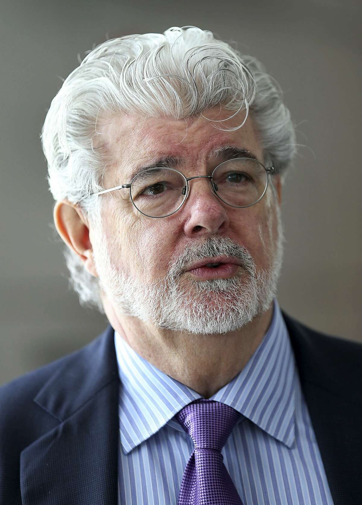 In this Jan. 16, 2014, photo George Lucas speaks in Singapore. For nearly a decade Lucas has been trying to build a museum for his extensive personal art collection. In January, the legendary filmmaker is expected to decide whether he will put the museum in San Francisco or Los Angeles, after other attempts were upended by community opposition. (AP Photo/Wong Maye-E, File)