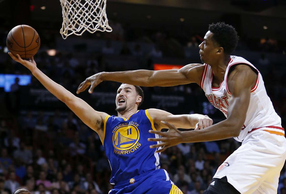 Golden State Warriors guard Klay Thompson (11) attempts a shot against Miami Heat center Hassan Whiteside during the first half of an NBA basketball game Wednesday, Feb. 24, 2016, in Miami. (AP Photo/Wilfredo Lee)