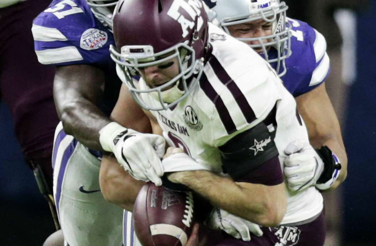 Texas A&M quarterback Trevor Knight fumbles as he is sacked by Kansas State defensive end Reggie Walker during the second quarter of the Texas Bowl at NRG Stadium on Dec. 28, 2016, in Houston.