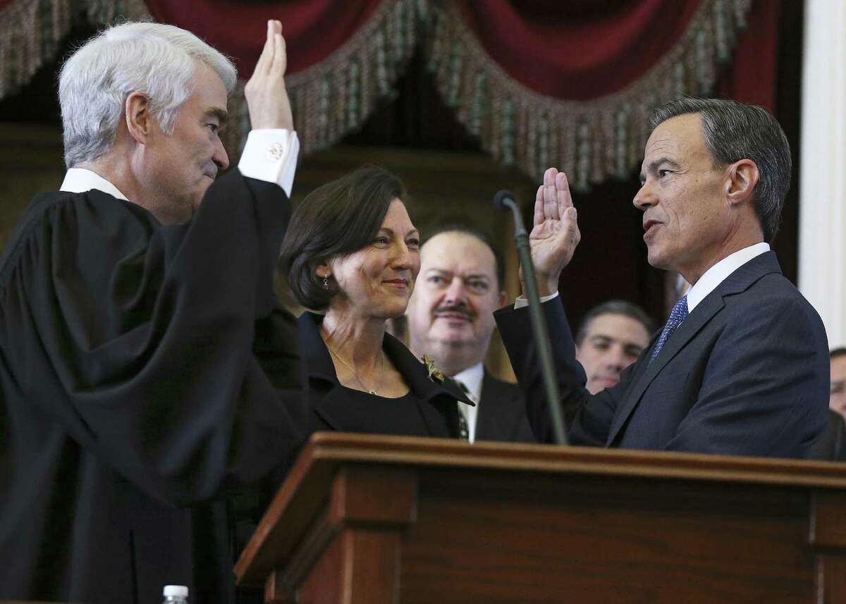 Joe Straus is sworn in to office by Texas Supreme Court Chief Justice Nathan Hecht as Julie Straus watches as the 85th Texas Legislative session opens on Jan. 10. Straus and Hecht agree this year on the need to end straight-party voting.