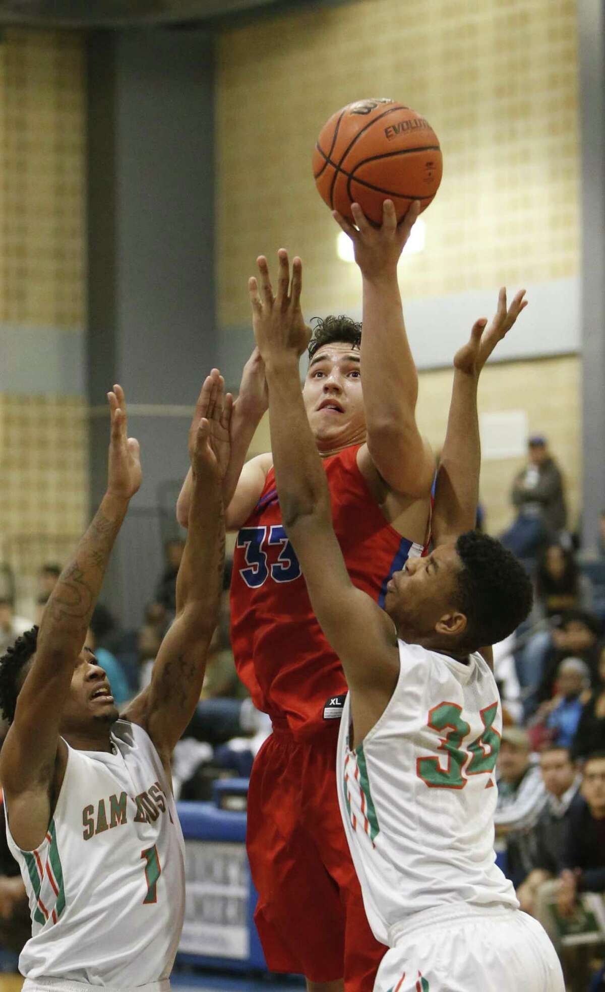 Jefferson’s Noah Soto shoots over Sam Houston’s Marquise Carter in a District 28-5A game on Jan. 10, 2017.