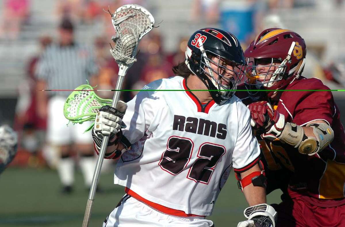 New Canaan's Cody Newton advances as St. Joseph's defender Kevin Riley tries to block him as New Canaan High School faces St. Joseph's in an FCIAC playoff game at Brien McMahon High School Tuesday afternoon, May 25, 2010. New Canaan won the game to advance to the FCIAC finals.