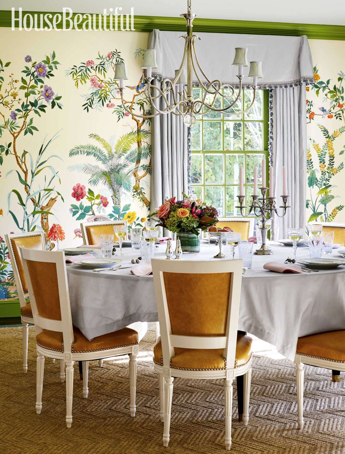 Bright, fresh colors dominate the dining room in Baily McCarthy's home. Tropical wallpaper, lime green trim and orange chairs add a vintage vibe.