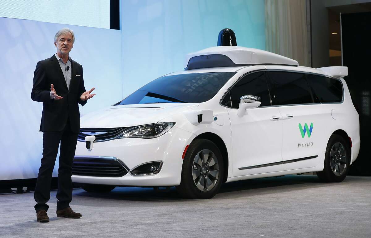 FILE - In this Sunday, Jan. 8, 2017, file photo, John Krafcik, CEO of Waymo, the autonomous vehicle company created by Google's parent company, Alphabet, introduces a Chrysler Pacifica hybrid outfitted with Waymo's own suite of sensors and radar, at the North American International Auto Show in Detroit. At the show, Waymo reiterated that it doesn’t plan to make its own cars, but wants to partner with established auto companies and others. (AP Photo/Paul Sancya, File)