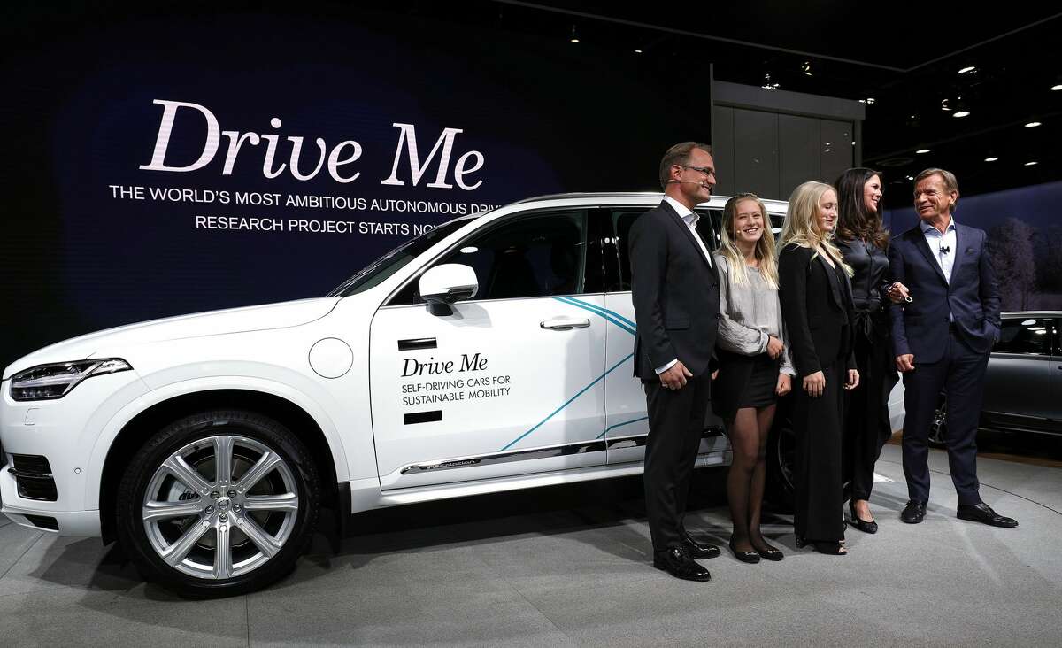 DETROIT, MI - JANUARY 9: Hakan Samuelsson (R), President and CEO, Volvo Car Group, stands with the Hain family from Sweden next to the autonomous Volvo vehicle they will be testing at the 2017 North American International Auto Show on January 9, 2017 in Detroit, Michigan. Approximately 5000 journalists from around the world and nearly 800,000 people are expected to attend the NAIAS between January 8th and January 22nd to see the more than 750 vehicles and numerous interactive displays. (Photo by Bill Pugliano/Getty Images)