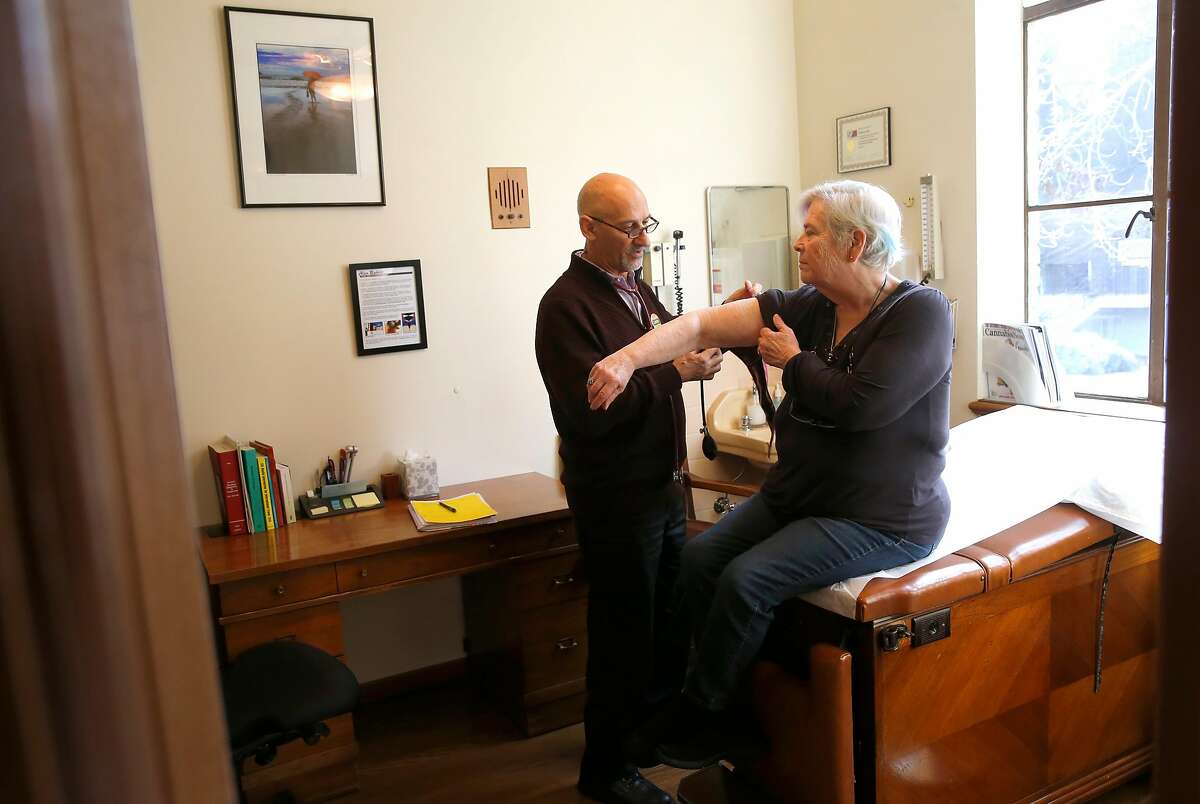 Dr. Frank Lucido meets with his patient Carla Newbre of Oakland in his office on Thursday Jan. 12, 2017, in Berkeley, Ca. Newbre was prescribed medical Cannabis by Dr. Lucido for her muscle spasms and pain.