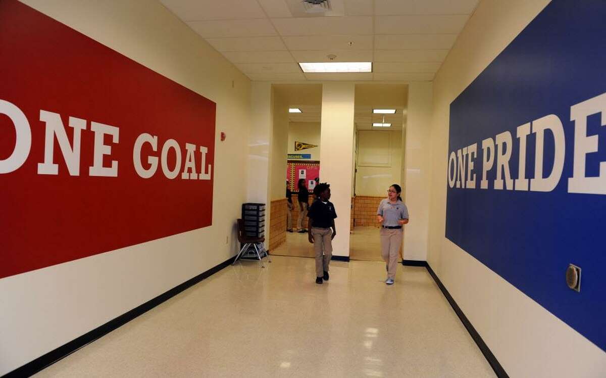 Fifth grade student Anthony Montgomery and eighth grade student Anabell Pichardo walk through the halls of the newly renovated Achievement First Bridgeport Academy Middle School in Bridgeport Thursday, May 31, 2012.