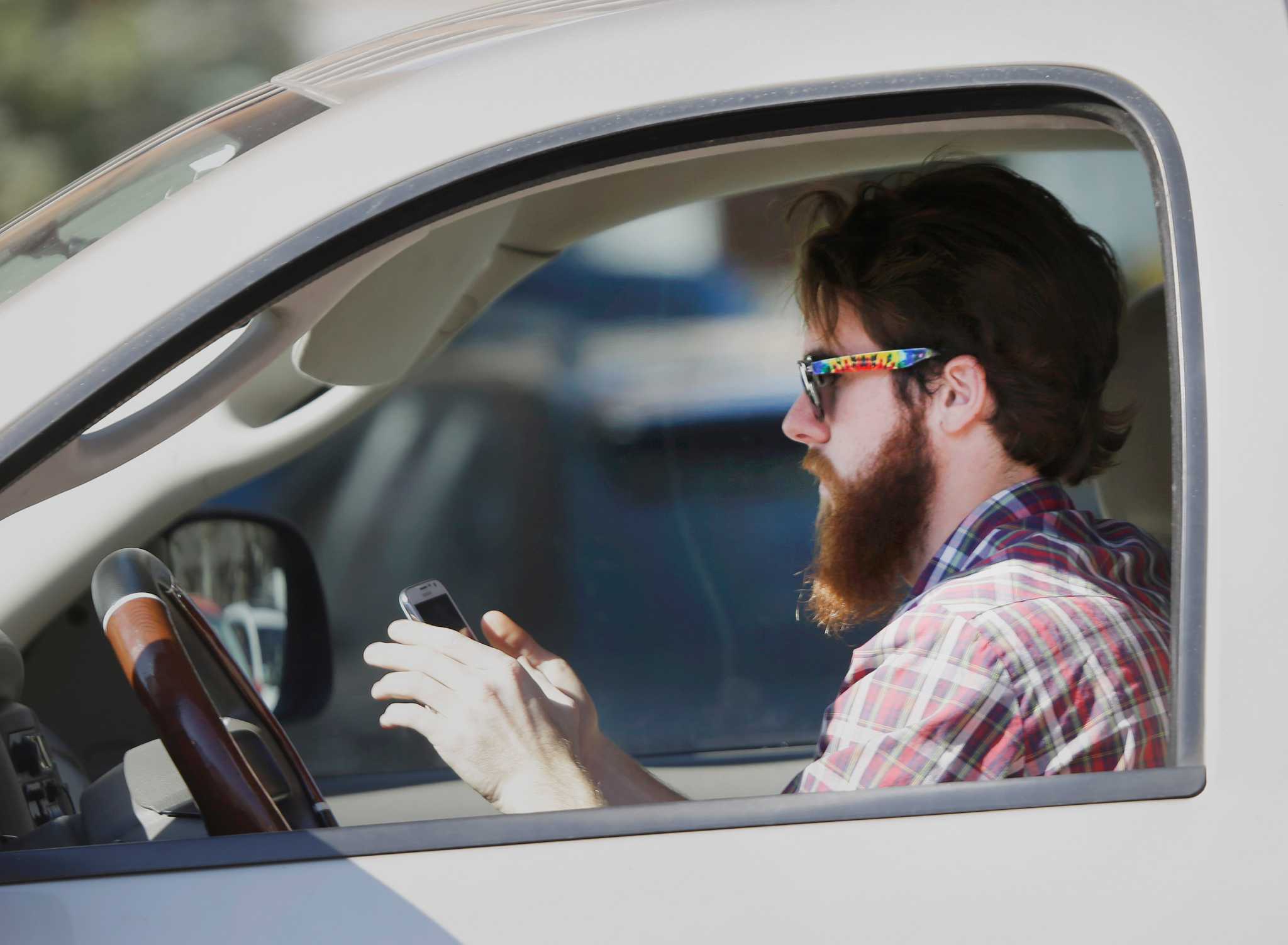 checking phone at red light