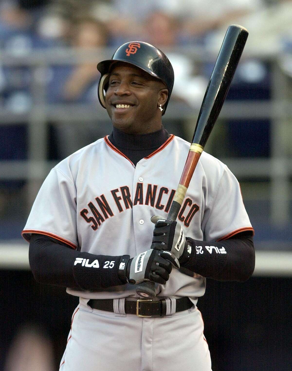 ** ADVANCE FOR WEEKEND EDITIONS, JUNE 15-16 -- FILE -- ** San Francisco Giants' Barry Bonds sports a big grin as he is intentionally walked in the first inning of the Giants game against the San Diego Padres in San Diego, in this June 3, 2002 photo. In 1998, Arizona manager Buck Showalter considered Bonds such a threat that he had him intentionally walked with the bases loaded. And that was years before Barry Bonds broke the single-season home run record.(AP Photo/Denis Poroy)