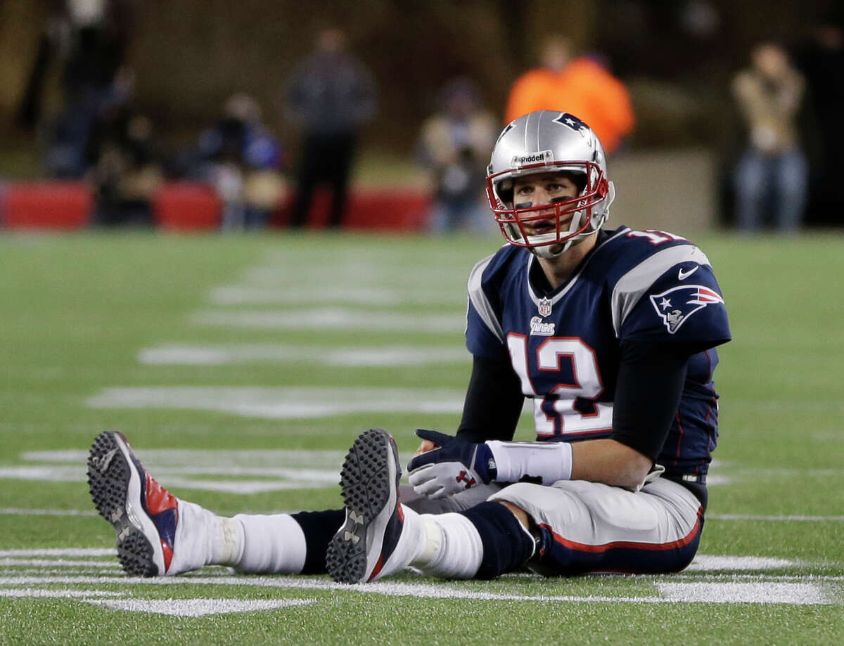 New England Patriots quarterback Tom Brady sits on the field after getting hit during the second half of the NFL football AFC Championship football game against the Baltimore Ravens in Foxborough, Mass., Sunday, Jan. 20, 2013. (AP Photo/Steven Senne)