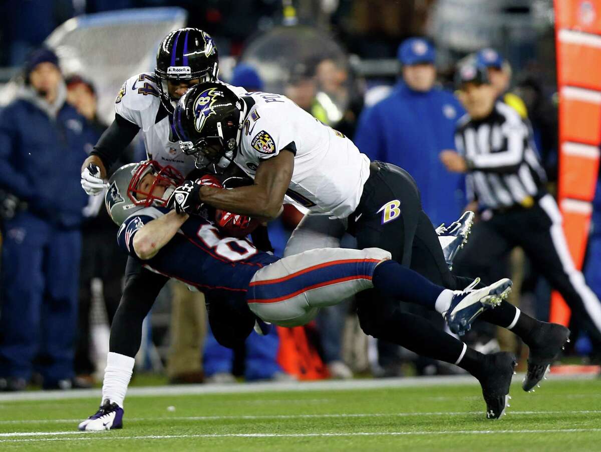 Wes Welker #83 of the New England Patriots catches a pass over Bernard Pollard #31 and Corey Graham #24 of the Baltimore Ravens during the 2013 AFC Championship game at Gillette Stadium on January 20, 2013 in Foxboro, Massachusetts. (Photo by Jared Wickerham/Getty Images)