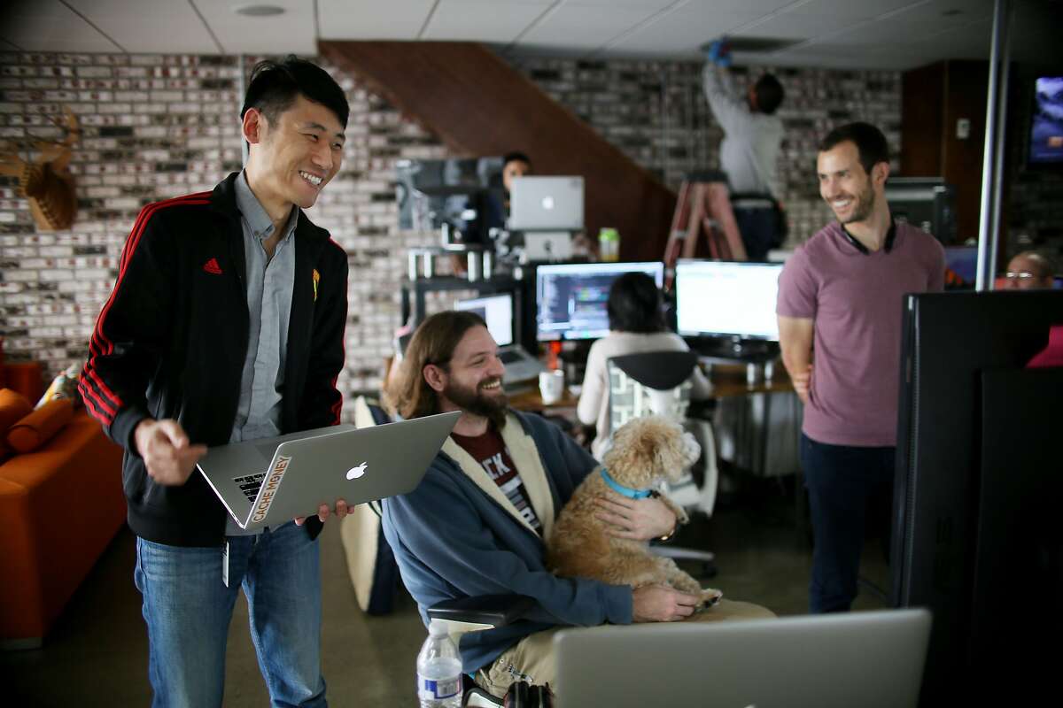 Kan Wang and engineer at Zeeto and an H-1B Visa holder, looks over a project with workmate Her Johnson at their offices in San Diego, CA on Friday, January 13, 2017. The Trump administration says it plans on changing the nation's immigration process and will likely look at reforming the H-1B visa program. Many tech firms hire people through this program and some companies and entrepreneurs are concerned about whether changes could impact their hiring process.Photo by Sandy Huffaker/Special to The Chronicle)