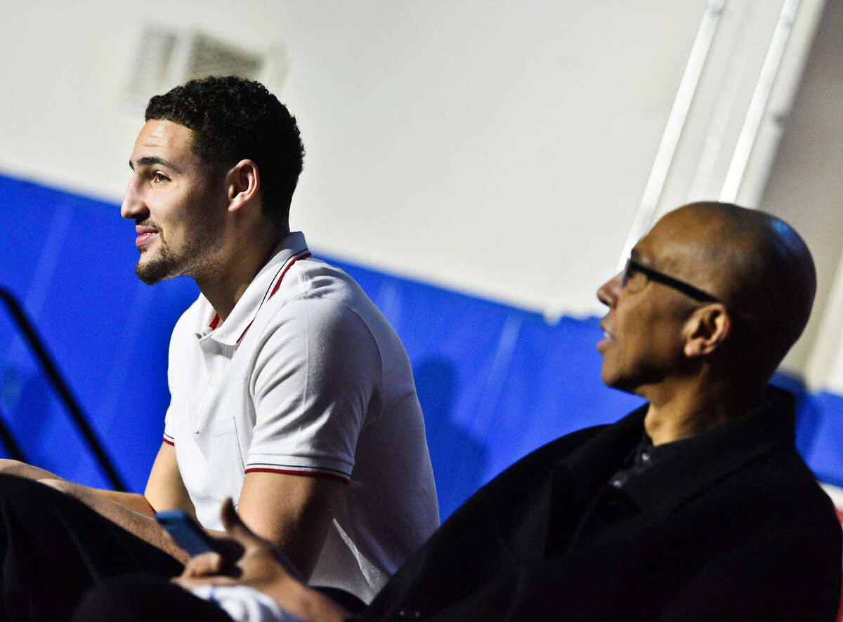 Klay Thompson left, and his father Mychal Thompson, right, during the retirement ceremony for Klay's jersey at Santa Margarita Catholic High School Friday. Golden State Warriors NBA player Klay Thompson has his jersey retired at his high school alma mater, Santa Margarita Catholic High School on Friday, Jan. 13, 2017 in Ranch Santa Margarita,Calif.