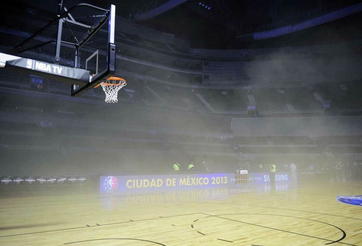 General view inside Mexico City Arena where players were evacuated because of smoke before the game between Minnesota Timberwolves and San Antonio Spurs in Mexico City on Dec. 4, 2013. A transformer burned and spread smoke on the court before the game.