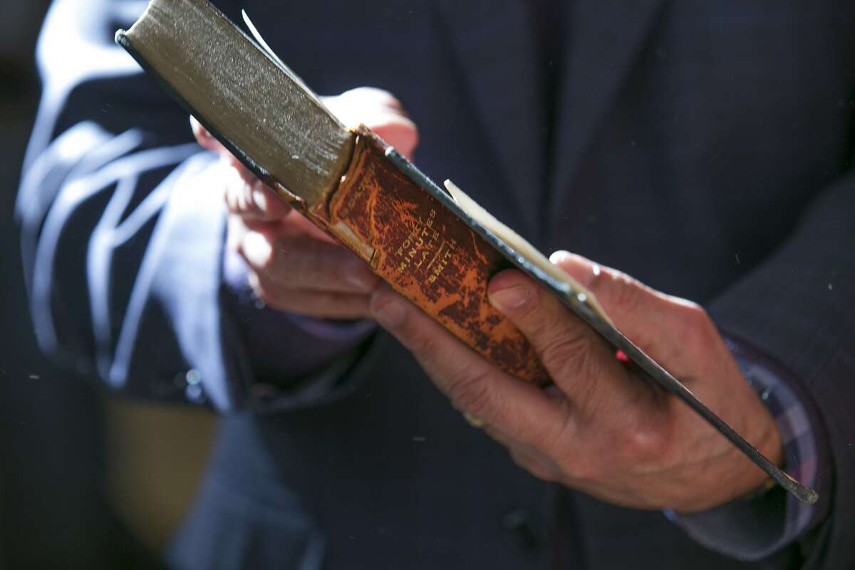 City Librarian Luis Herrera holds the book "Forty Minutes Late" at the San Francisco Public Library Park Branch on Friday, Jan. 13, 2017 in San Francisco, Calif. It was returned today during the library's Fine Forgiveness Program. The book has a 1917 due-date stamp.