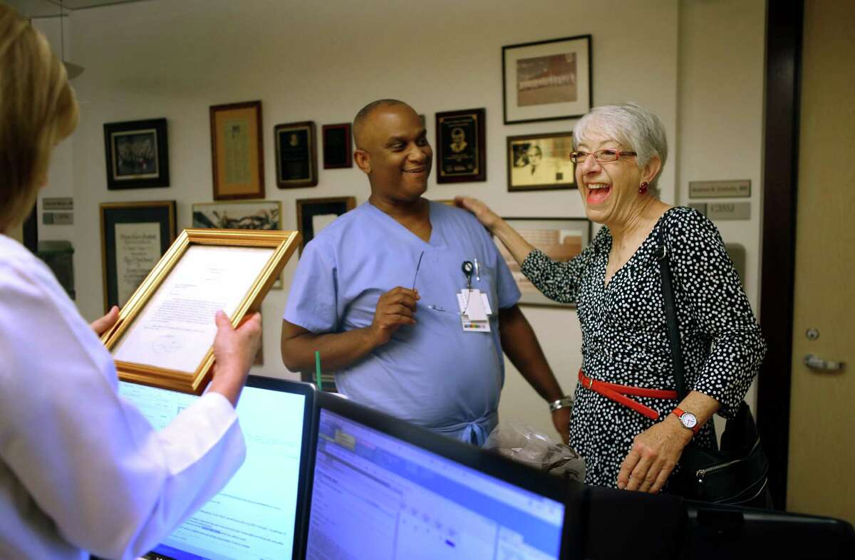 Anne Bunting laughs with staff at the Texas Heart Institute, Friday, Jan. 13, 2016, in Houston. Bunting received a heart transplant after the Affordable Care Act went into effect in 2014. After writing a letter to President Obama thanking them last year, she recently received a letter back from the president.