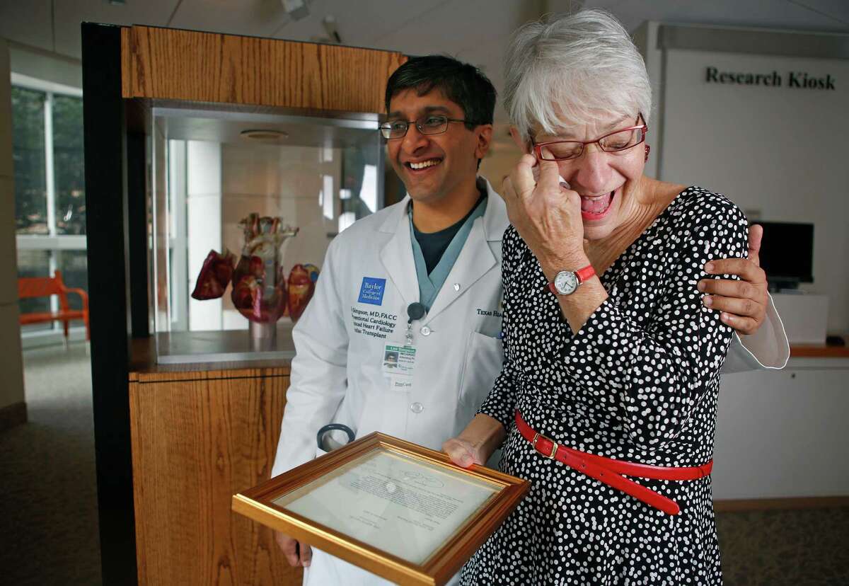 Cardiologist Dr. Leo Simpson hugs a tearful Anne Bunting in the Wallace D. Wilson Museum at the Texas Heart Institute, Friday, Jan. 13, 2016, in Houston. Bunting received a heart transplant after the Affordable Care Act went into effect in 2014. After writing a letter to President Obama thanking them last year, she recently received a letter back from the president.