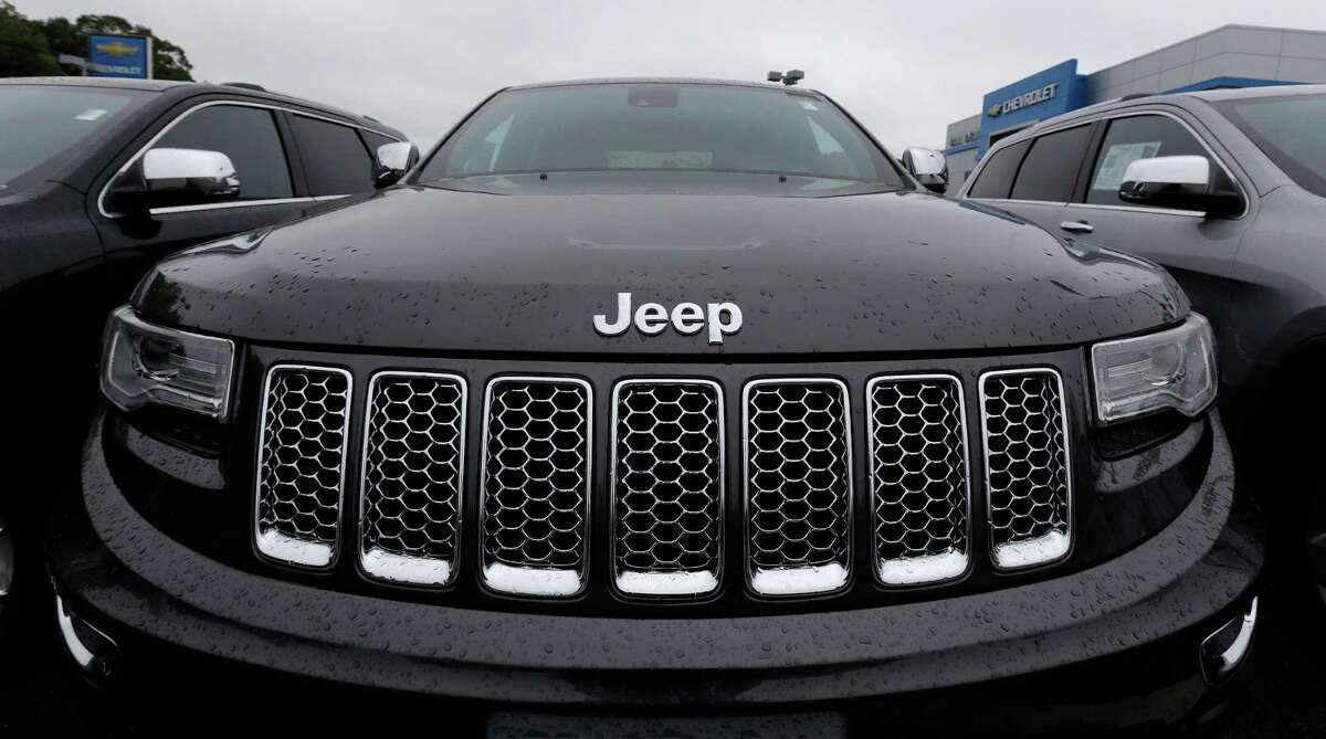 FILE - This Oct. 1, 2014, file photo, shows the hood of a Jeep Grand Cherokee at Bill DeLuca's dealerships in Haverhill, Mass. On Thursday, Jan. 12, 2017, the U.S. government alleged that Fiat Chrysler Automobiles failed to disclose that software in some of its pickups and SUVs with diesel engines allows them to emit more pollution than allowed under the Clean Air Act. The Environmental Protection Agency said in a statement that it issued a "notice of violation" to the company that covers about 104,000 vehicles, including the 2014 through 2016 Jeep Grand Cherokee and Dodge Ram pickups, all with 3-liter diesel engines. (AP Photo/Charles Krupa, File)