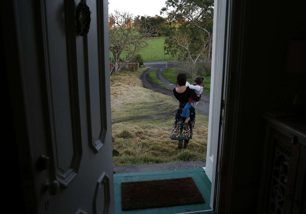Belle Sweeney walks to the mailbox with two of her children, who she preferred not to name, as dusk falls at her home Jan. 5, 2017 in Sebastopol, Calif.