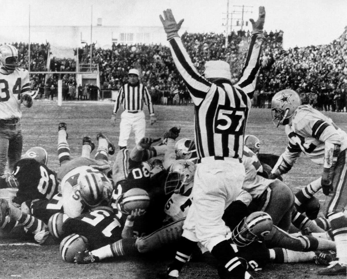 Green Bay quarterback Bart Starr (15) dives across the goal line to score the winning touchdown against Dallas at Lambeau Field on Dec. 31, 1967, in what is known in NFL annals as the Ice Bowl.