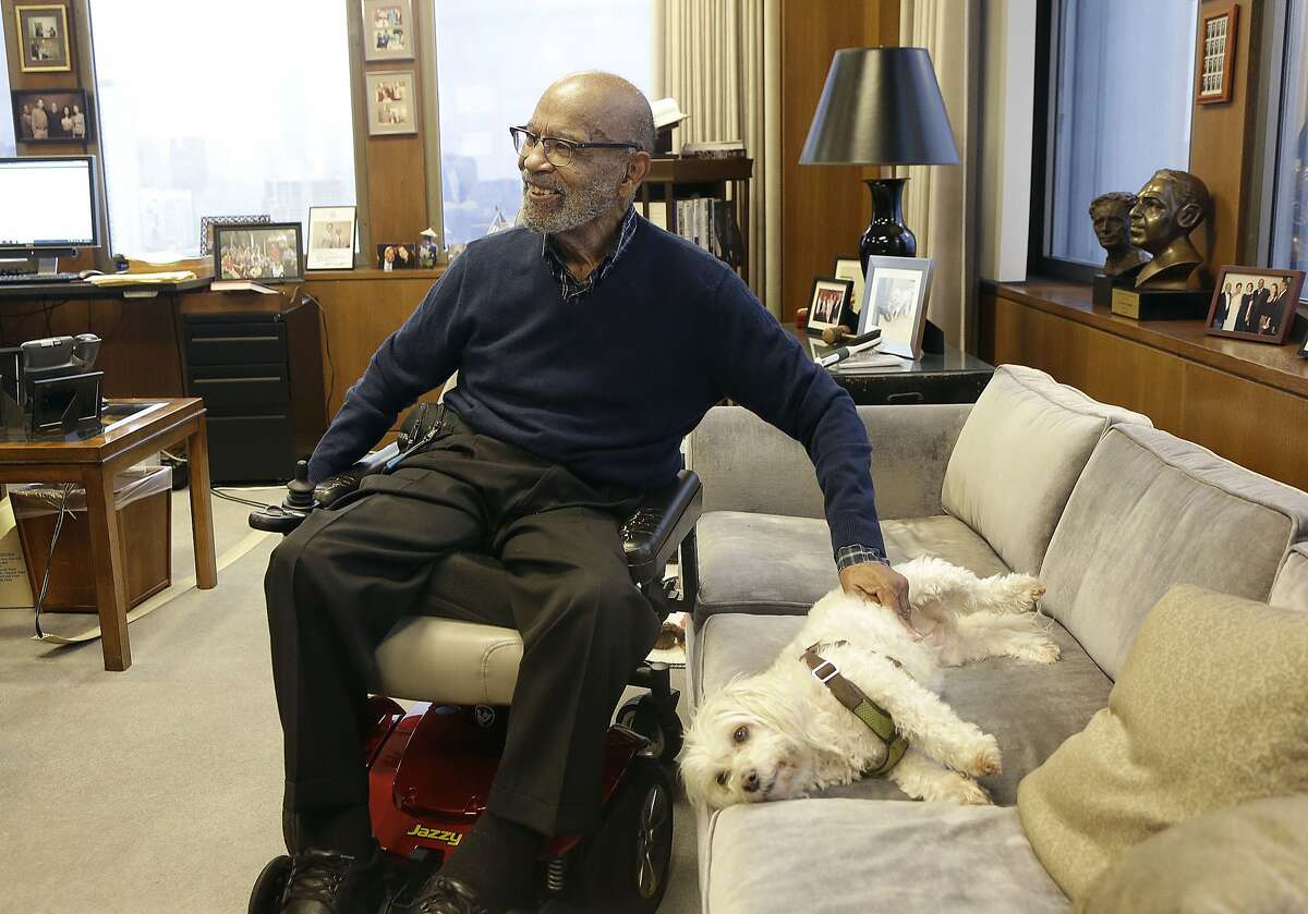 U.S. District Court Judge Thelton Henderson pets his dog Missy while interviewed in his chambers in San Francisco, Tuesday, Jan. 10, 2017. Henderson, the first African-American attorney in the Justice Department's civil rights division, says he knows there will be more civil rights battles under the Trump administration, but at 83, he no longer has the energy to fight them. (AP Photo/Jeff Chiu)