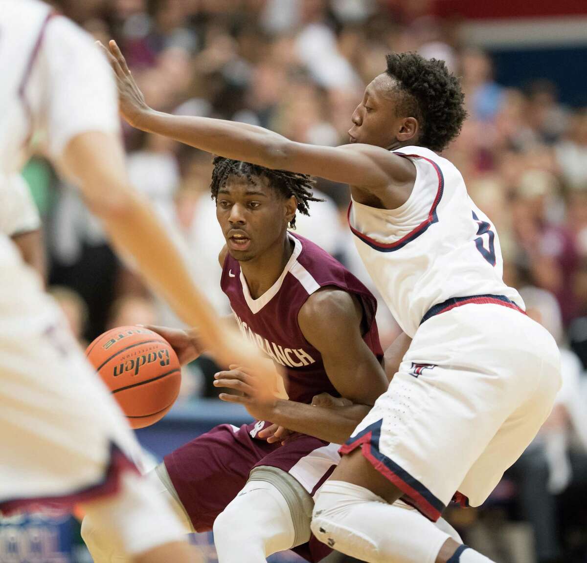 Cinco Ranch's Jay Jay Chandler, left, led all scorers with 31 points, but his Cougars couldn't keep pace with Tompkins in the 65-55 loss Friday night.﻿