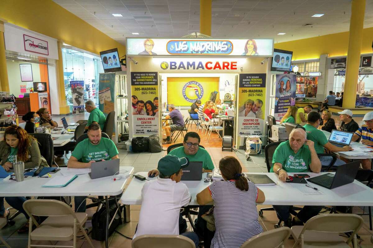 Customers sign up for coverage under the Affordable Care Act at a mall kiosk in Miami in November. The Internal Revenue Service is sending personalized letters to millions of taxpayers who might be uninsured. ﻿