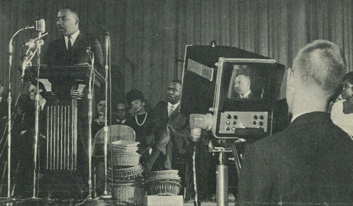John E. Maher, then a sophomore at Darien High School, films the Rev. Martin Luther King Jr. speaking at Stamford High School on Nov. 30, 1964. Maher says King spoke so forcefully that when he shifted to the left and reached around to adjust the zoom lens in the front of the camera, he could feel King’s breath on his hand.