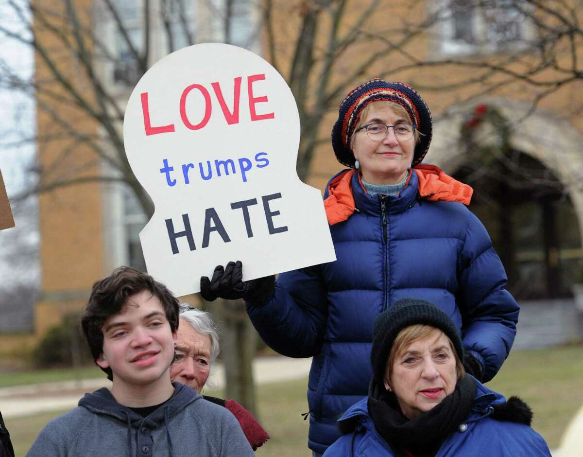 Patricia Kantorski of Greenwich holds a "Love Trumps Hate" sign during the Anti-Hate Rally lead by Greenwich Selectman Drew Marzullo on Greenwich Avenue in Greenwich, Conn., Saturday afternoon, Jan. 14, 2017. Thirty people gathered as Selectman Marzullo spoke to the crowd preaching a message of love and inclusion for all in American society.