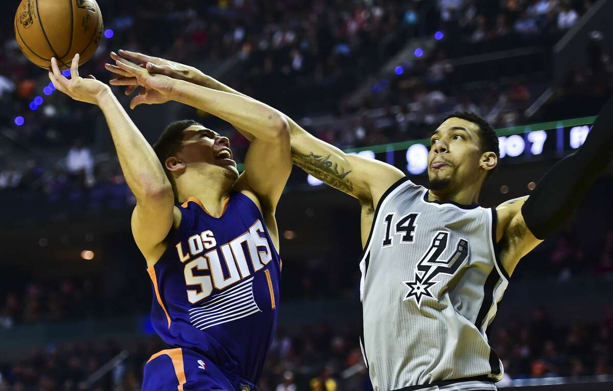 Phoenix Suns Devin Booker (L) vies for the ball with San Antonio Spurs´ Dany Green (R), during an NBA Global Games match at the Mexico City Arena, on January 14, 2017, in Mexico City. / AFP PHOTO / RONALDO SCHEMIDTRONALDO SCHEMIDT/AFP/Getty Images