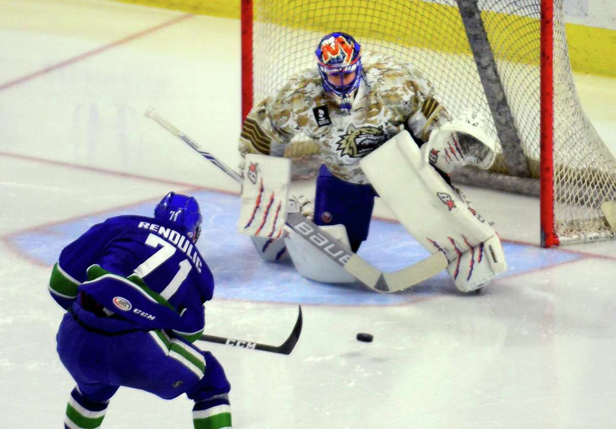 Sound Tigers goalie Jaroslav Halak prepares to block a goal attempt by Utica Comets' Borna Rendulic during hockey action at the Webster Bank Arena in Bridgeport, Conn., on Saturday Jan. 14, 2017.