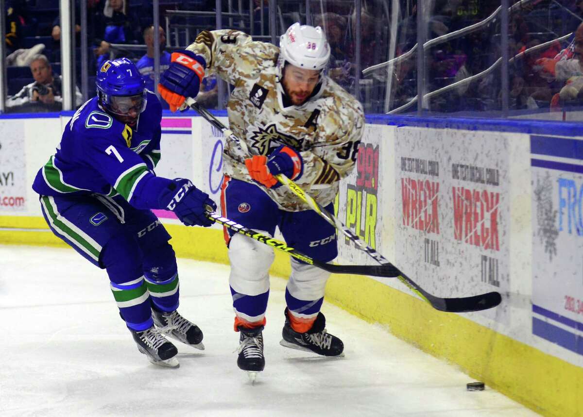 Utica Comets Jordan Subban, left, tries to cut off Sound Tigers Bracken Kearns as he goes behind the goal for the puck during hockey action at the Webster Bank Arena in Bridgeport, Conn., on Saturday Jan. 14, 2017.