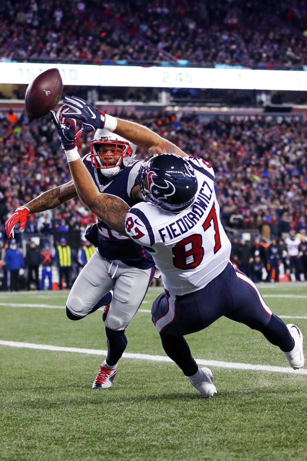 Houston Texans tight end C.J. Fiedorowicz (87) misses a touchdown pass while being defended by New England Patriots strong safety Patrick Chung (23) during the first quarter of an NFL divisional playoff game at Gillette Stadium, Saturday, January 14, 2017. ( Karen Warren / Houston Chronicle )