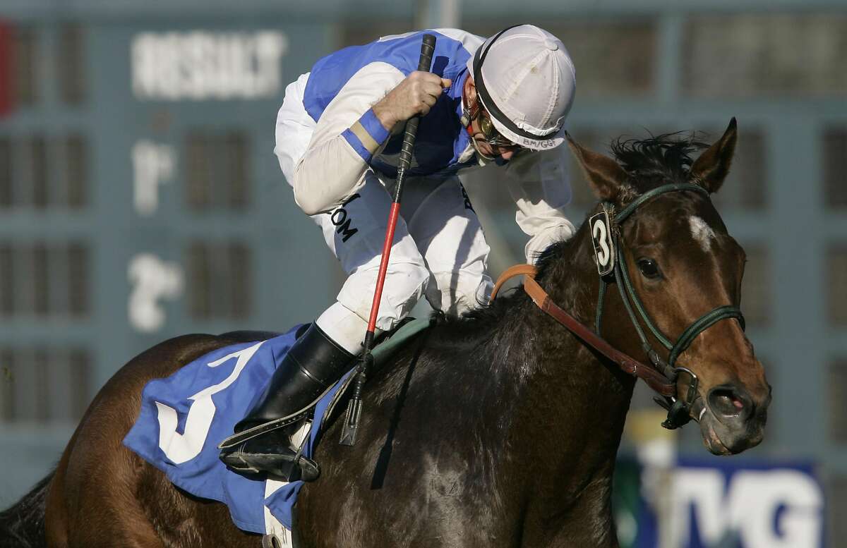 Jockey Russell Baze pumps his fist after winning the fourth race at Bay Meadows in San Mateo, Calif., Friday, Dec. 1, 2006. It was Baze's 9,531st victory to eclipse Laffit Pincay Jr.'s career record to become thoroughbred racing's winningest jockey. (AP Photo/Jeff Chiu)