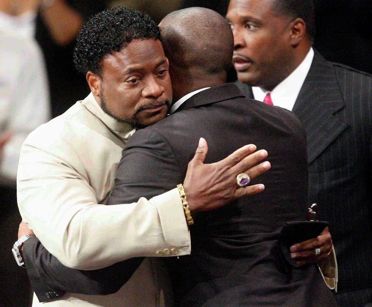 Bishop Eddie Long, left, embraces a friend in 2010 after a scandal erupted in which four young men accused him of sexual misconduct. The cases were settled out of court.