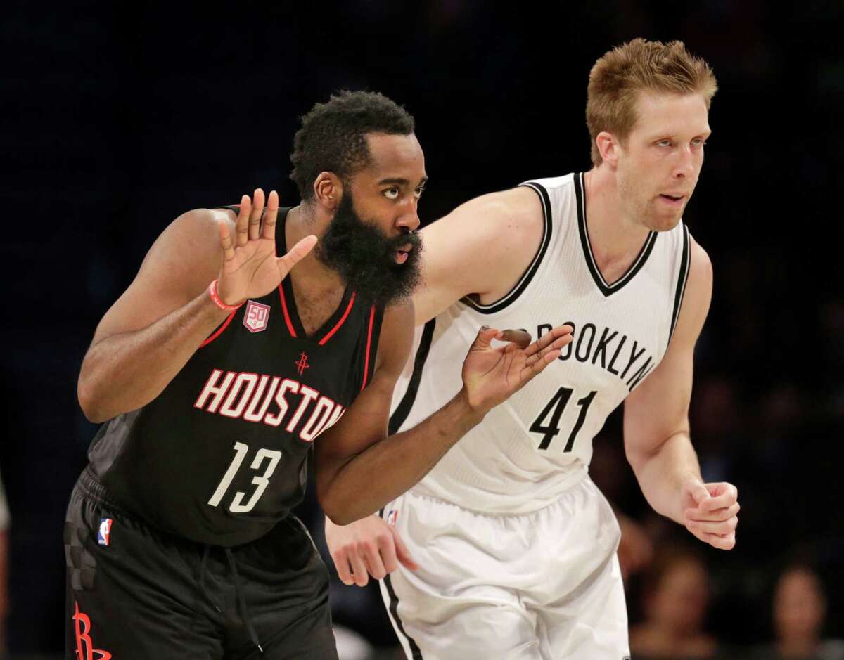 Rockets guard James Harden (13) makes sure the Nets' Justin Hamilton knows his shot just went in.