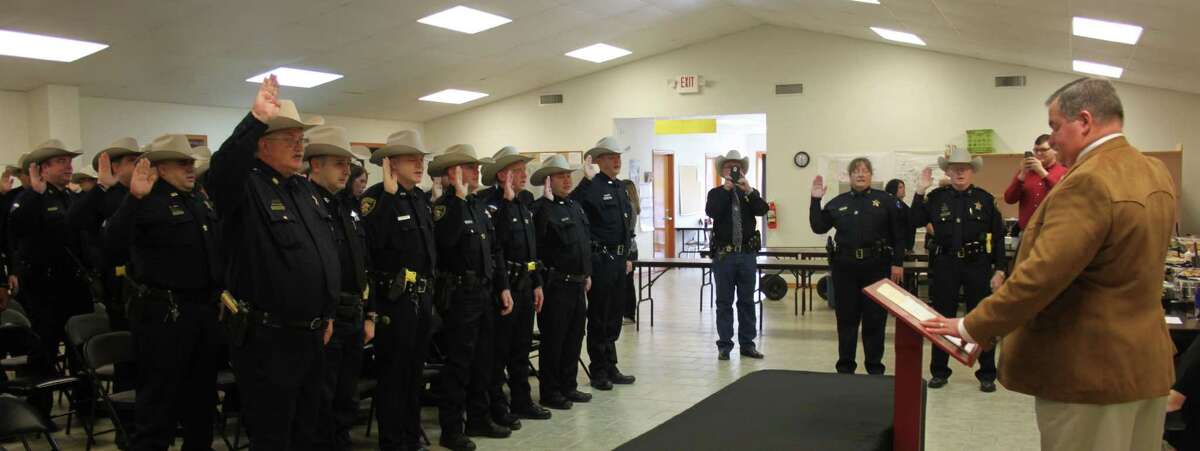 Sheriff Greg Capers (right) swears in law enforcement officers for the 2017 year.
