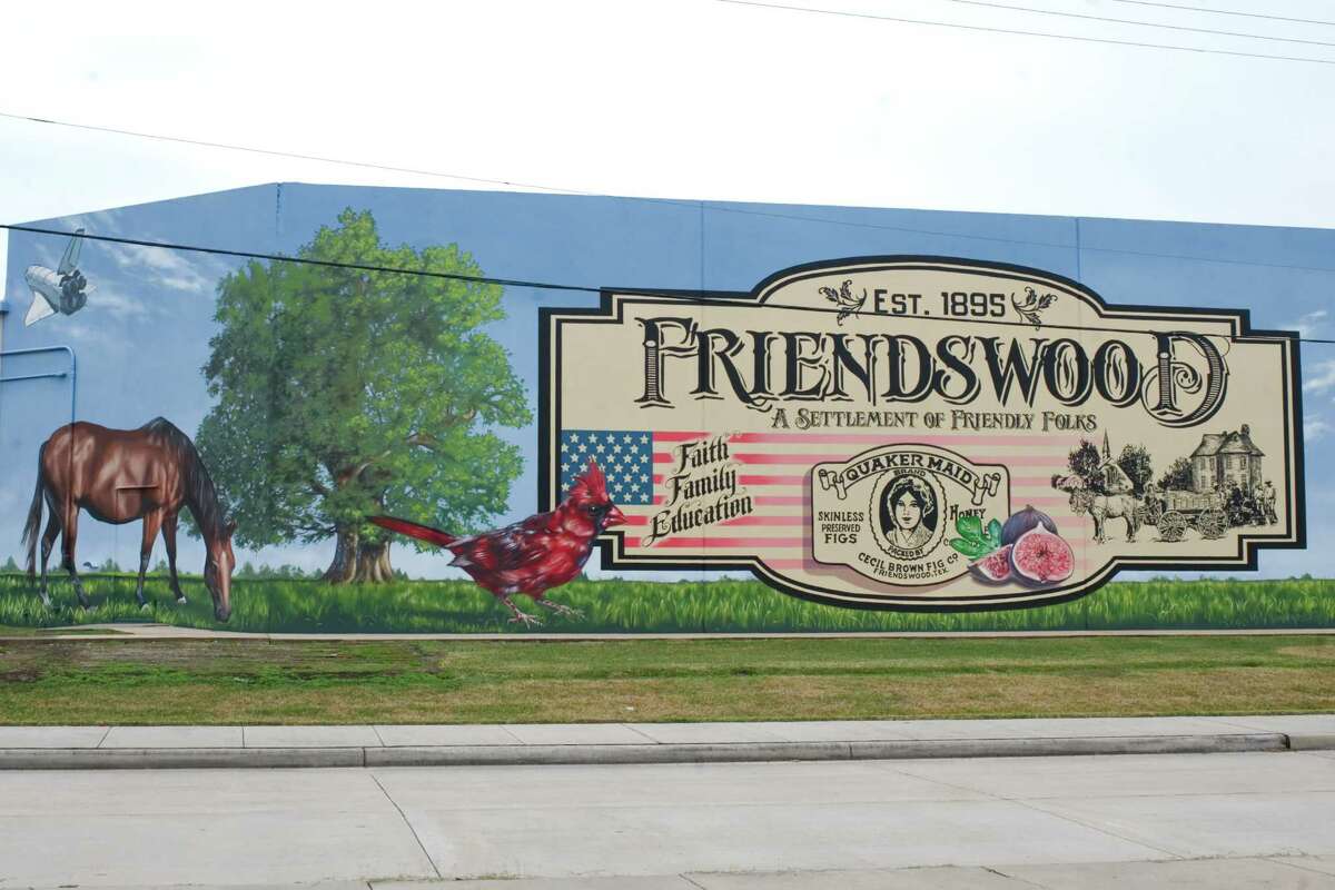 Painted on a 2,000-foot-long wall, a mural in Friendswood portrays some of the things that symbolize the community's heritage, including figs. an important early source of income for residents.