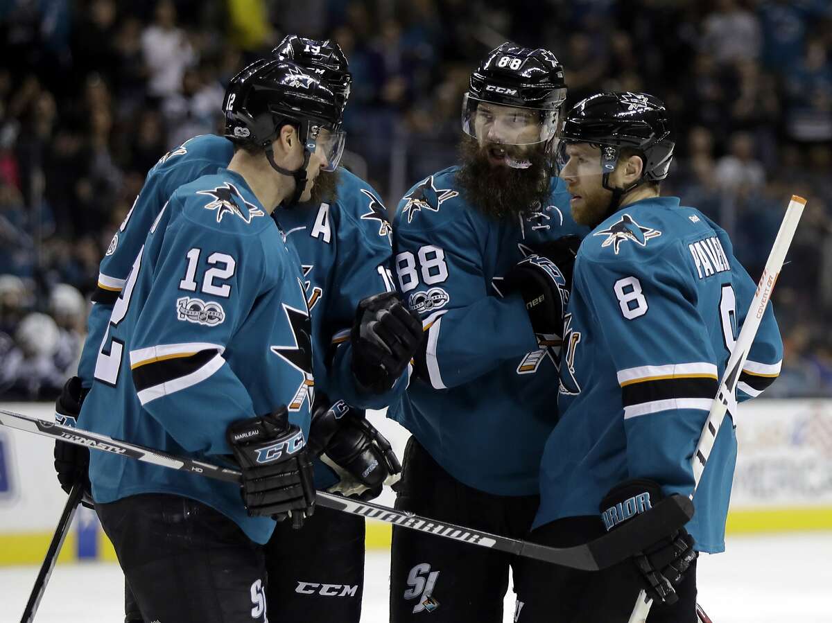 San Jose Sharks' Brent Burns (88) celebrates his goal with teammates Joe Pavelski (8), Patrick Marleau (12) and Joe Thornton, second from left, during the second period of an NHL hockey game against the Winnipeg Jets, Monday, Jan. 16, 2017, in San Jose, Calif. (AP Photo/Marcio Jose Sanchez)