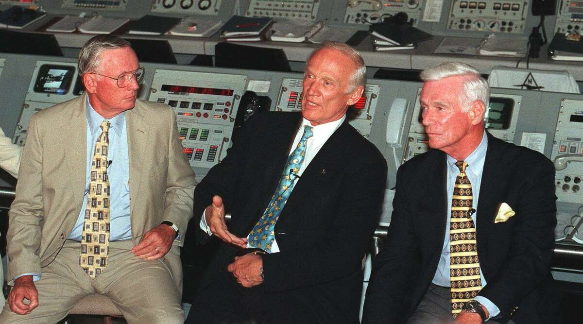 Apollo 11's Neil Armstrong, left, and Gene Cernan, right, listen to the other member of the Apollo 11 crew "Buzz" Aldrin tell out-of-this world stories at Kennedy Space Center in 1999.