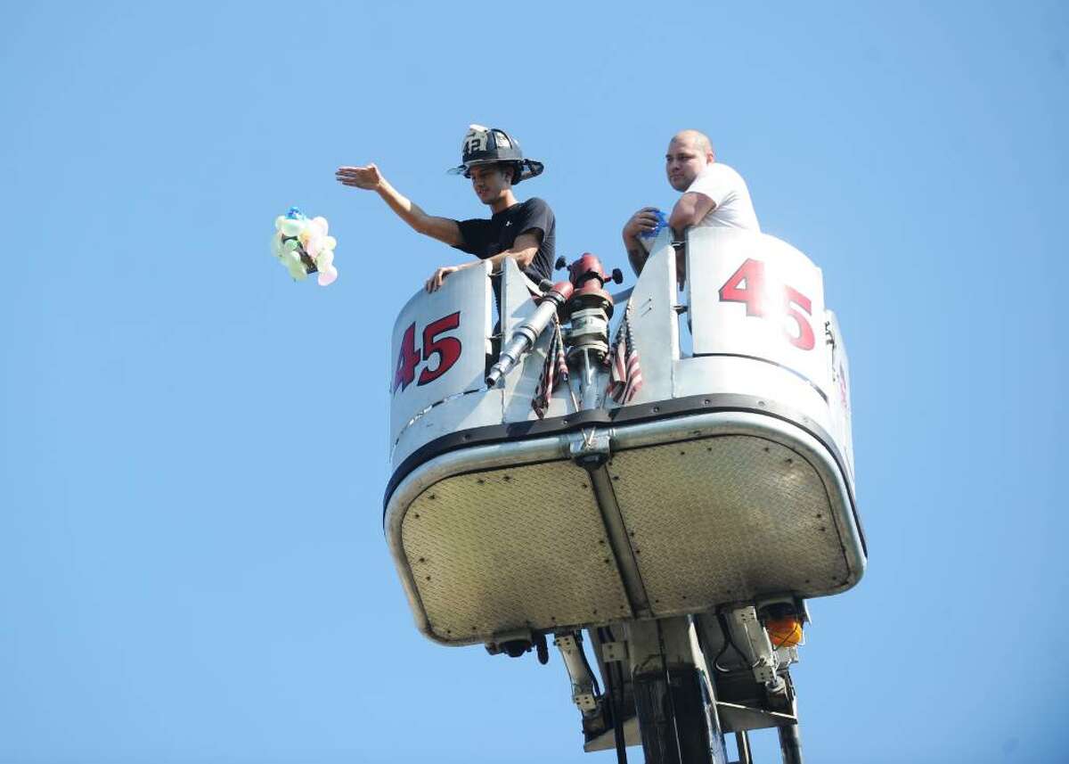 Matt Corsello, from the Belltown Firehouse, drops units from a ladder truck as eighth graders at Dolan Middle School participate in the finals of the Egg Drop with their hand made units in Stamford, Conn. on Wednesday May 26, 2010.