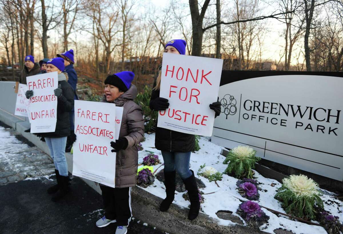 Indiana Y. Pena, left, of Port Chester, N.Y., Rosa Vasquez, center, of Stamford, and Mayra Maurad, of Port Chester, N.Y., hold up sign in protest outside Greenwich Office Park in Greenwich, Conn. Monday, Jan. 16, 2017. Former cleaners at Greenwich Office Park are demanding that Fareri Associates reinstate the 11 employees whom the building owners displaced from their jobs. On Nov. 4, the building owners ended their relationship with a cleaning contractor and did not rehire many of the workers left without jobs. The National Labor Relations Board is now investingating Fareri Associates for unfair labor practices.