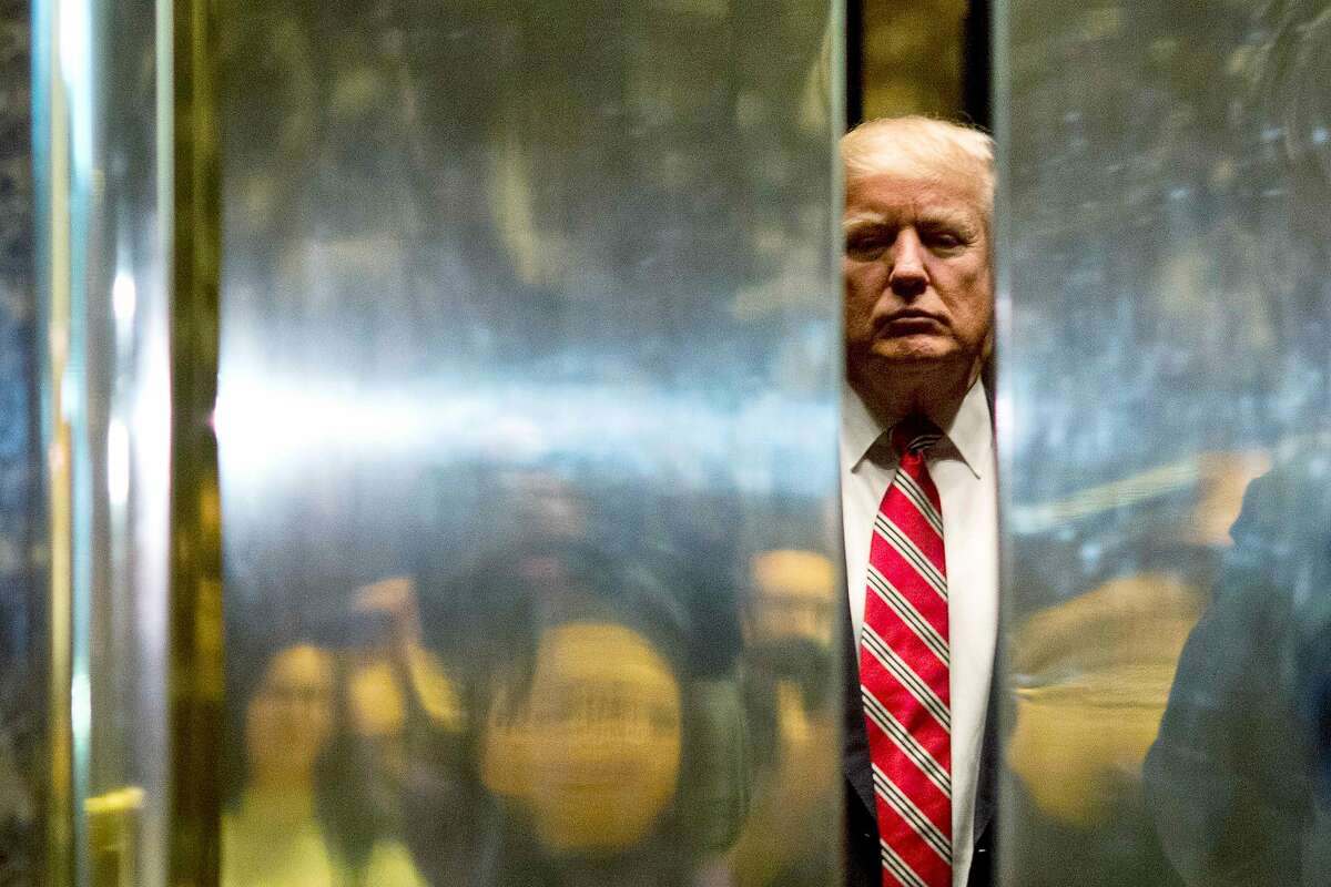 US President-elect Donald Trump boards the elevator after escorting Martin Luther King III to the lobby after meetings at Trump Tower in New York City on January 16, 2017. / AFP PHOTO / DOMINICK REUTERDOMINICK REUTER/AFP/Getty Images