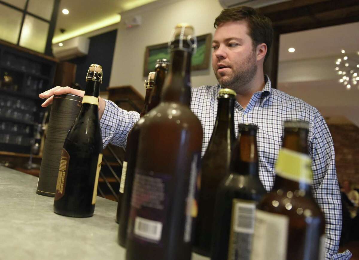 Owner Geoff Lazlo shows the variety of unique beers available at Mill Street Bar & Table in the Byram section of Greenwich, Conn. Thursday, Jan. 12, 2017. Lazlo is trying to get his own brewing operation off the ground and begin selling homemade beer, made with natural ingredients, in his restaurant which specializes in farm-to-table meals.