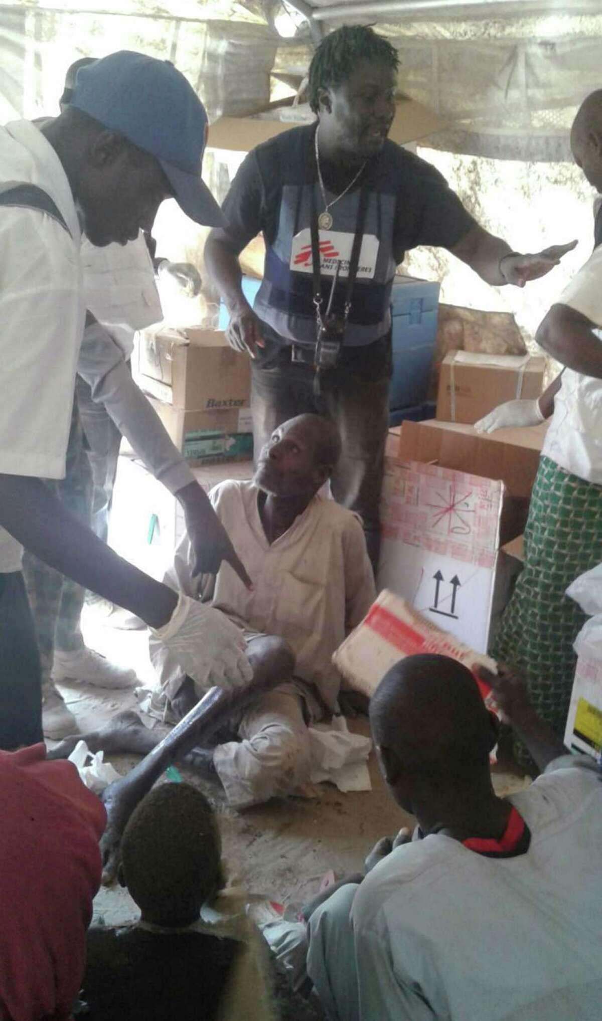 In this image supplied by MSF, victims receive first aid following a military air strike at a camp for displaced people in Rann, Nigeria, Tuesday Jan. 17, 2017. Relief volunteers are believed to be among the more than 100 dead after a Nigerian Air Force jet fighter mistakenly bombed the refugee camp, while on a mission against Boko Haram extremists. (Medecins Sans Frontieres (MSF) via AP)
