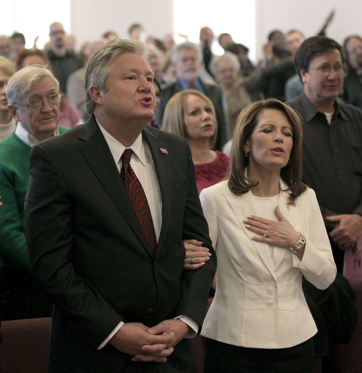 Then-Republican presidential candidate, Rep. Michele Bachmann, R-Minn., and her husband Marcus attend services at Jubilee Family Church in Oskaloosa, Iowa, Sunday, Jan, 1, 2012. (AP Photo/Charlie Riedel)