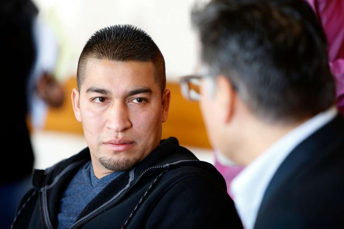 Mission district resident Pedro Figueroa-Zarceno talks about his two month immigration detention after reporting his car being stolen to police as he talks to supervisor John Avalos during a press conference in city hall in San Francisco, California, on Friday, February 5, 2016.