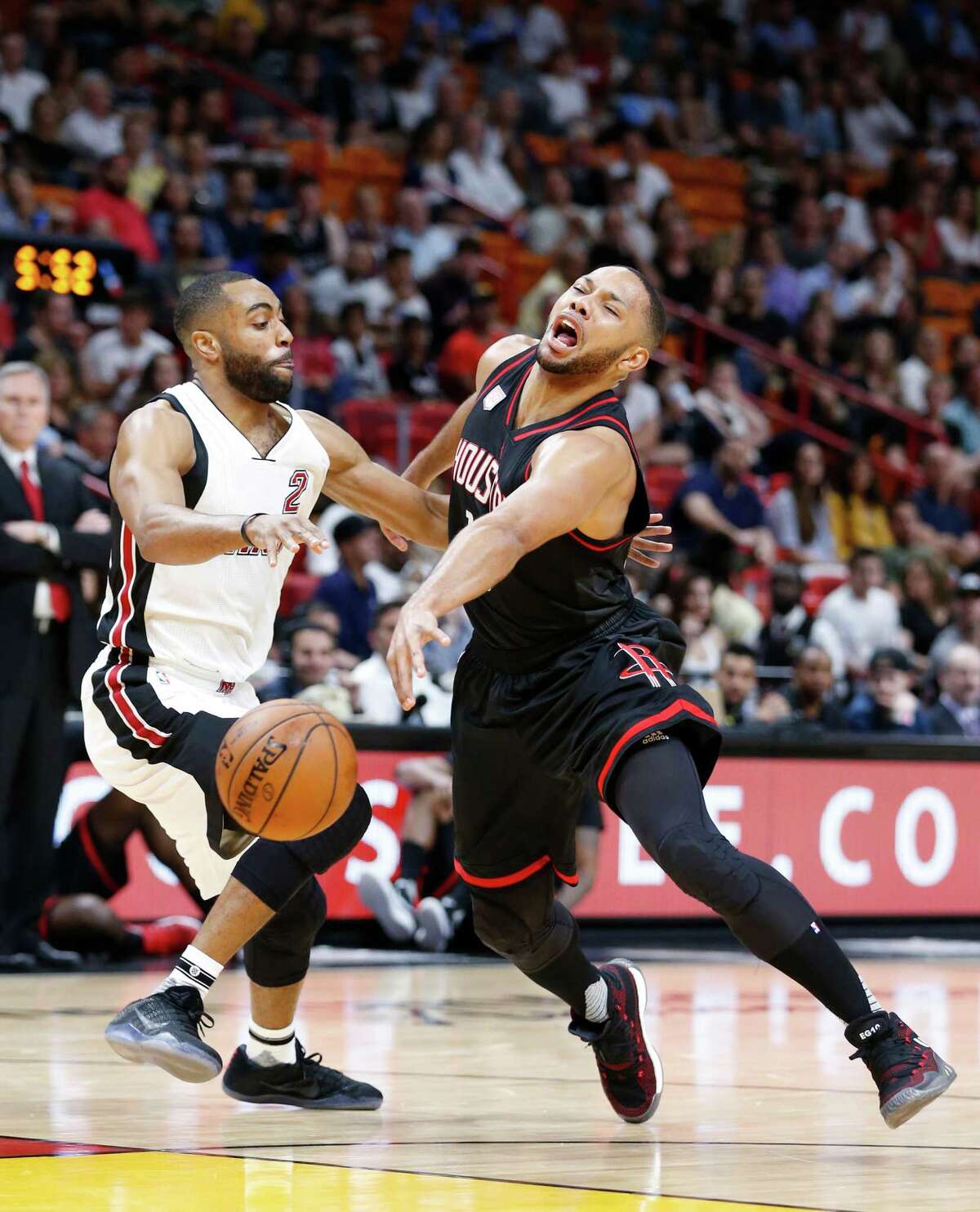 Houston Rockets guard Eric Gordon, left, loses control of the ball as he goes up for a shot against Miami Heat guard Wayne Ellington (2) during the first half of an NBA basketball game, Tuesday, Jan. 17, 2017, in Miami. (AP Photo/Wilfredo Lee)
